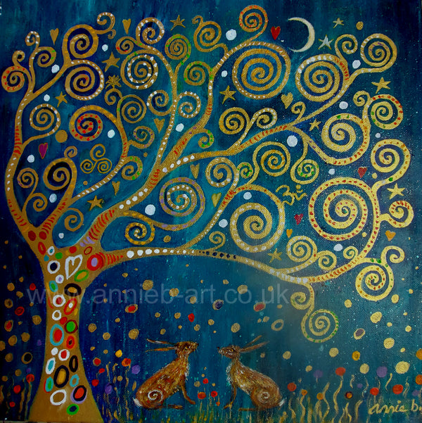 Two hares bask under the glow of the magical golden Tree of life on a deep turquoise background. Original mixed media painting on deep edge box canvas ready for your walls Size 40cm x 40cm. Spiritual art. Klimt style art. Tree of life. Aum.  Animal wisdom