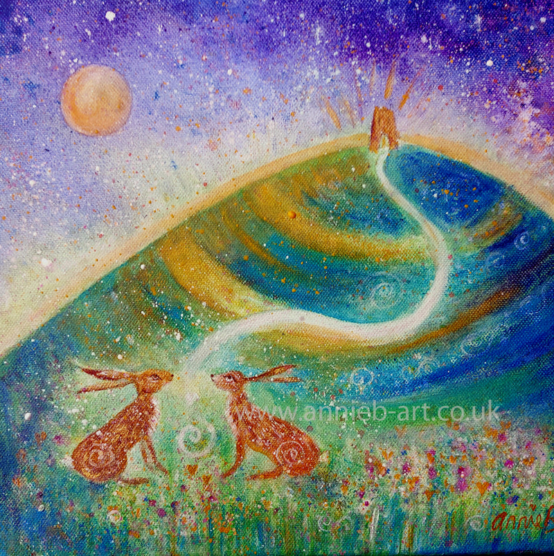 Two hares sit under the magic of Glastonbury Tor  under a full moon sky.   A small original painting in mixed media on deep edge boxed canvas with a hint of gold and sparkle ready for your walls