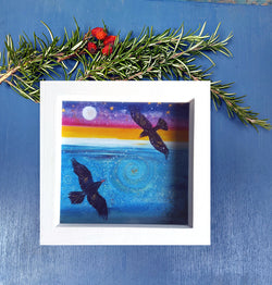 A mini print of 'Choughs flying high', hand finished  with a touch of gold and sparkle in a white deep wooden frame  ready for your walls or the perfect. Cornish choughs, wild birds. ocean . Cornwall artist. annie b.