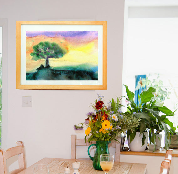 A water colour painting of a gentle happy tree with a purple orange yellow sky.  I paint intuitively and allow the paint to flow and the image to form the magic on the canvas.  Landscape fine art print available with two options to choose from printed in Cornwall: