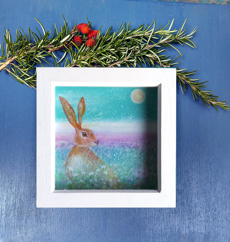 A mini print of 'Hare in the spring flowers', hand finished ;with a touch of gold and sparkle in a white deep wooden frame ready for your walls. the perfect gift.  ancient stone circle, Pagan. Stone henge. hare art. full moon. annie b. art. hare art. wild flowers