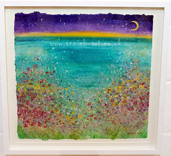 Cornish wild flowers dance happily above a Cornish cove under a new moon.  A large mixed medium painting on hand made paper, mounted and framed with a white washed wooden frame ready for your walls to uplift any space.