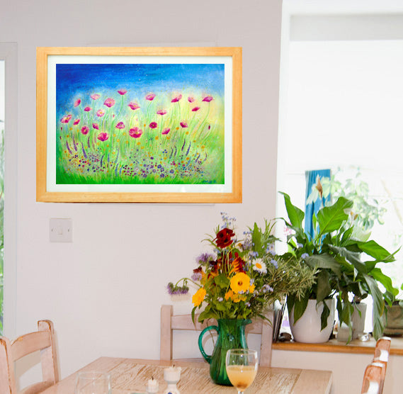 Wild pink poppies dance in the beautiful wild flower meadow under a blue summer sky.  Poppy art. Wild flower art.   Landscape fine art print available with two options to choose from printed in Cornwall: